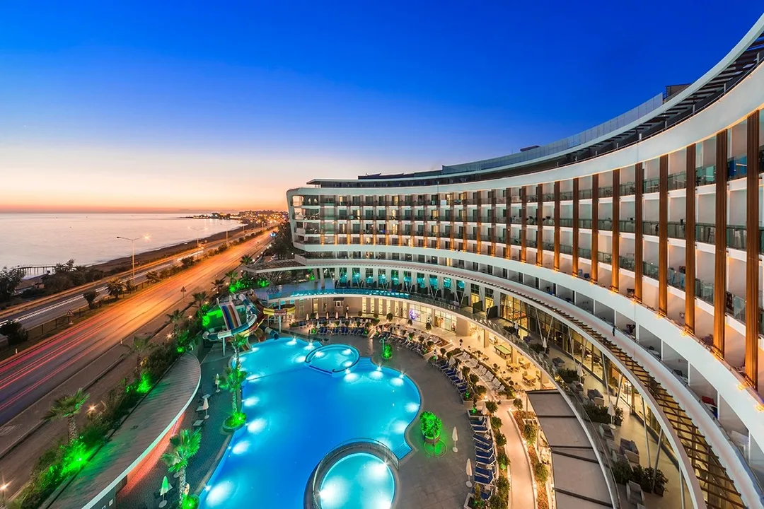 An agency's own photo of a beach hotel at dusk